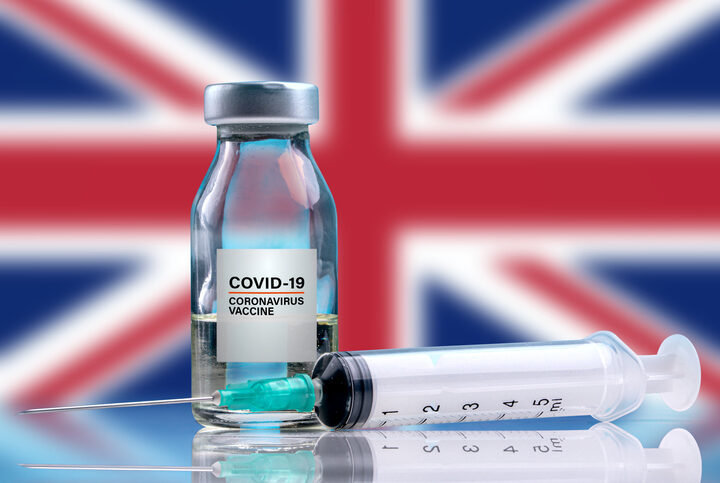 Vaccine and syringe injection. It use for prevention, immunization and treatment from corona virus infection (novel coronavirus disease 2019, Covid-19). England Flag background.